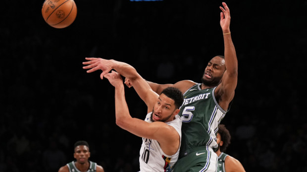 Ben Simmons #10 of the Brooklyn Nets and Alec Burks #5 of the Detroit Pistons battle for the loose ball during the game at Barclays Center on January 26, 2023 in New York City. 