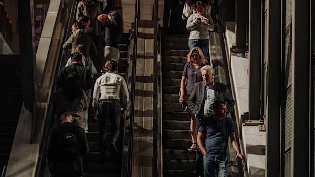 Pedestrians and office workers walk through the Sydney CBD. 