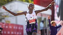 Ruth Chepngetich of Kenya crosses the finish line of the Chicago Marathon to win in world record time.