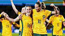 Hayley Raso and Emily Van Egmond celebrate after the Matildas' convincing 2-0 win over Denmark.