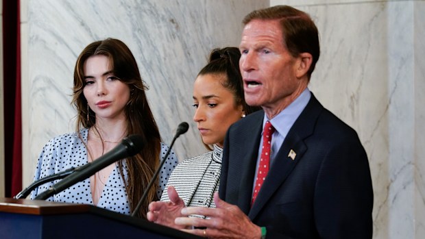 From left, United States gymnasts McKayla Maroney, and Aly Raisman listen as Sen. Richard Blumenthal, D-Conn., holds a news conference after the athletes testified before the Senate Judiciary Committee. 