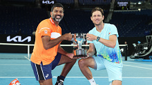 MELBOURNE, AUSTRALIA - JANUARY 27: Rohan Bopanna of India and Matthew Ebden of Australia pose with the championship trophy after their Mens Doubles Final match against Simone Bolelli and Andrea Vavassori of Italy during the 2024 Australian Open at Melbourne Park on January 27, 2024 in Melbourne, Australia. (Photo by Daniel Pockett/Getty Images)