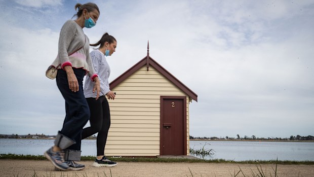 People walk around Lake Wendouree in Ballarat, Victoria, where restrictions have eased.