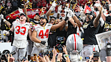 ATLANTA, GA  JANUARY 20:  Ohio State players celebrate with the winning trophy following the conclusion of the the Ohio State Buckeyes versus Notre Dame Fighting Irish College Football Playoff National Championship game on January 20, 2025, at Mercedes-Benz Stadium in Atlanta, GA.  (Photo by Rich von Biberstein/Icon Sportswire via Getty Images)