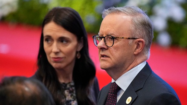 Australia's Prime Minister Anthony Albanese, right, and New Zealand's Prime Minister Jacinda Ardern react during ASEAN - East Asia Summit in Phnom Penh, Cambodia, Cambodia, Sunday, Nov. 13, 2022. (AP Photo/Vincent Thian)
