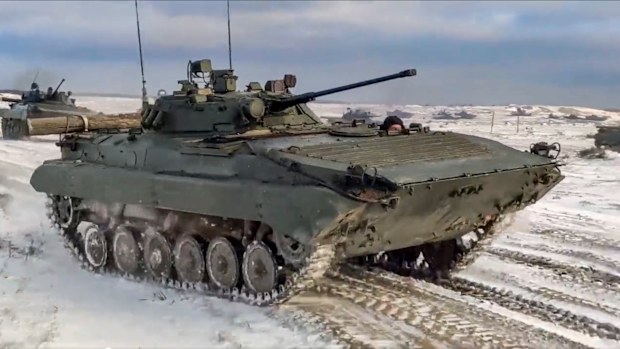In this photo taken from video and released by the Russian Defense Ministry Press Service on Wednesday, Feb. 2, 2022, Russian and Belarusian armored vehicles drive during a joint military drills at Brestsky firing range, Belarus.  