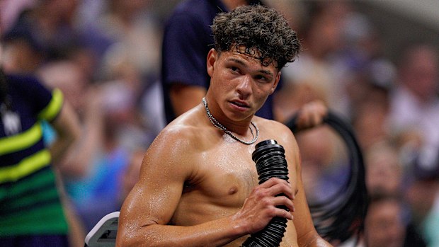 America's Ben Shelton blows cold air on his body during a break between games against Frances Tiafoe during their quarter final at the US Open. 