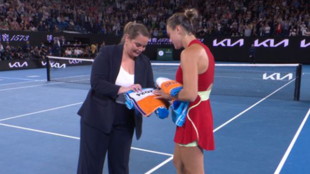 Jelena Dokic and Aryna Sabalenka sign towels.