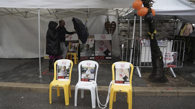 A poster shows slain hostages Oded Lifshitz, left, Ariel Bibas, center, and Kfir Bibas, right, whose bodies were released from the Gaza Strip, in Jerusalem, Friday, Feb. 21, 2025. (AP Photo/Mahmoud Illean)