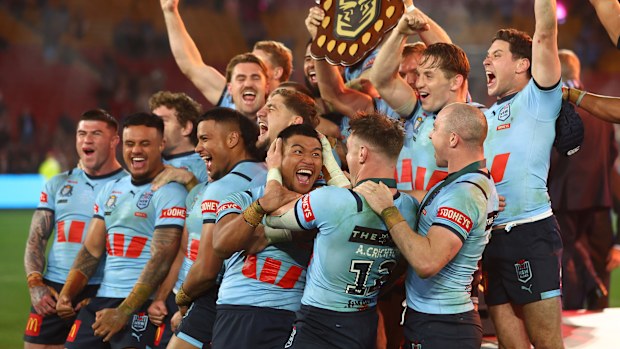 NSW Blues players celebrate after lifting the shield as winners of the 2024 State of Origin series.