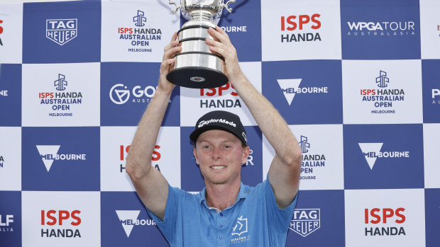 Ryggs Johnston poses with the Stonehaven Cup after victory on day four of the Australian Open 2024.