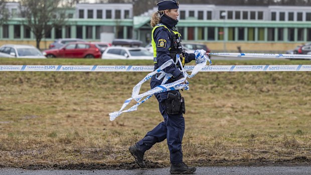 Police officers cordon off the crime scene with barricade tape. on February 5, 2025 in Orebro, Sweden. 