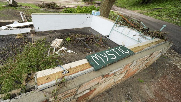 A Camp Mystic sign is seen near the entrance to the establishment along the banks of the Guadalupe River after a flash flood swept through the area in Hunt, Texas, Saturday, July 5, 2025. (AP Photo/Julio Cortez)