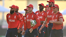 Jos Buttler leads his team off the field after their victory.