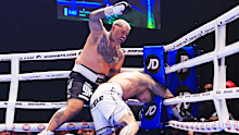 Mark Hunt throws a punch as Sonny Bill Williams goes down.