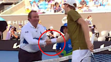 The chair umpire realises Jannik Sinner is wearing a Whoop device.
