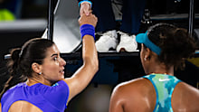 Sorana Cirstea of Romania argues with Naomi Osaka of Japan at the net.