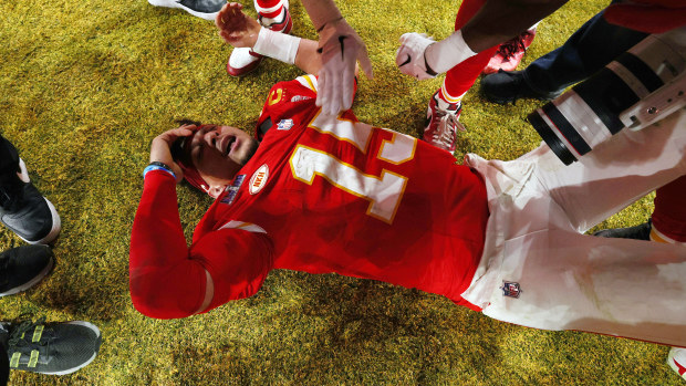 Patrick Mahomes of the Kansas City Chiefs on the ground celebrating defeating the San Francisco 49ers.