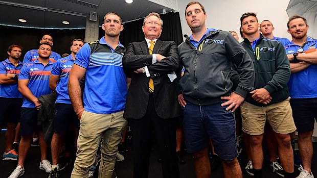 Andrew Forrest stands in front of Western Force players.