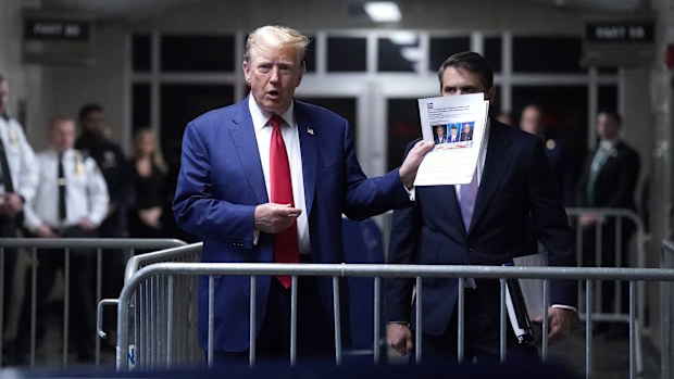 Former President Donald Trump, with attorney Todd Blanche, right, arrives at Manhattan criminal court in New York, on Friday, May 10, 2024. 