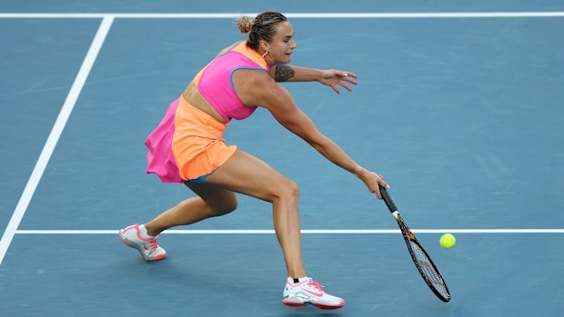 Aryna Sabalenka hitting a powerful forehand shot during her first-round match at the 2026 Australian Open.
