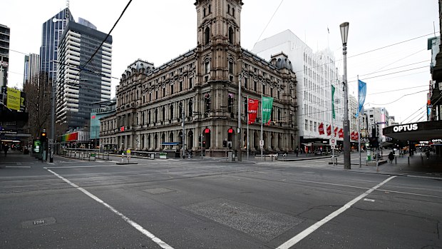 MELBOURNE, AUSTRALIA - JULY 20: A quiet intersection is seen along Bourke Street on July 20, 2021 in Melbourne, Australia. Victoria is under strict lockdown as the state continues to record new community COVID-19 cases and work to stop the spread of the highly infectious delta coronavirus strain in the community. (Photo by Daniel Pockett/Getty Images)