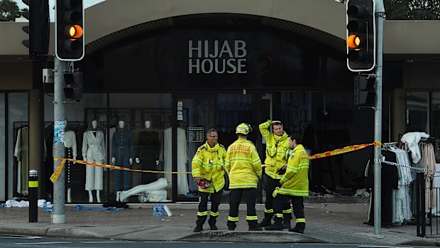 NSW fire department stand in front of the shop Hijab House in Sydney where a car drove into the shop, injuring twelve people including the driver.