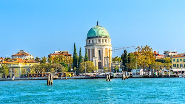 Grand Canal Tempio Votivo War Memorial Church Ferry Dock Restaurants Lido Venice Italy. Tempio Votivo was built between 1925 to 1935 for the War dead and last religious monument in the Venice Lagoon.