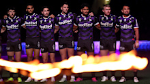 Storm players during the Anzac Day ceremony prior to their clash with the Rabbitohs.