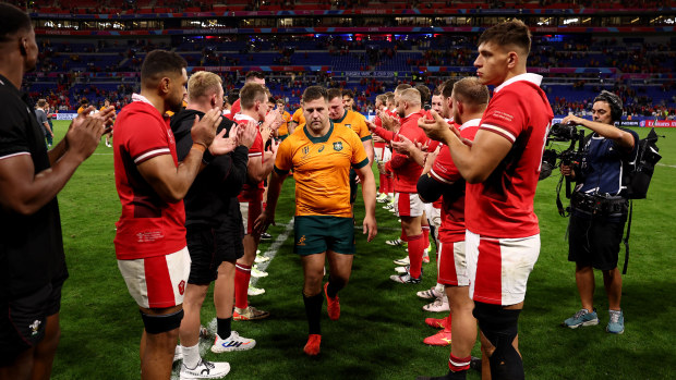The players of Wales give the players of Australia a guard of honour as they leave the pitch at full-time.