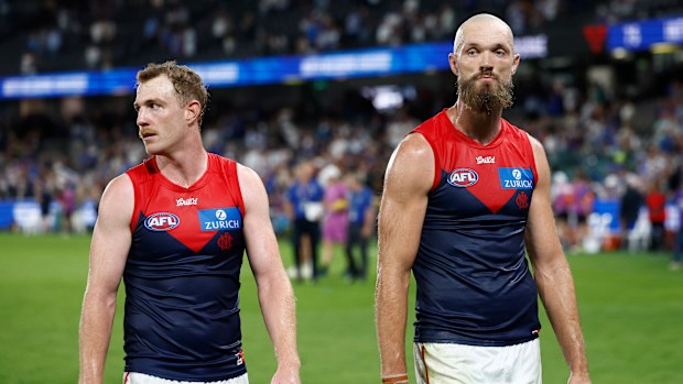 Melbourne's Max Gawn and Harry Petty leave the field after the loss to North Melbourne. 