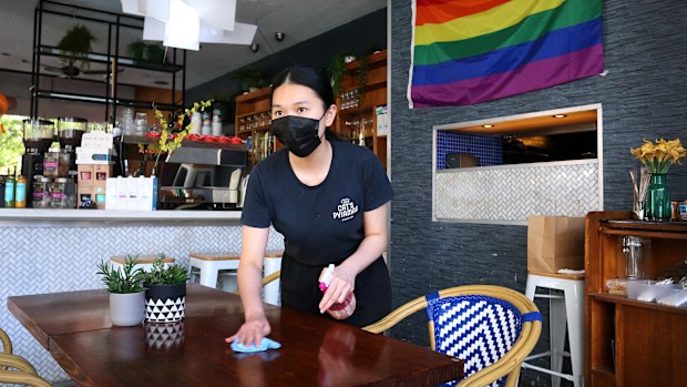 Co-owner Elaine Stephanie prepares to welcome back seated patrons at The Pelican Hills cafe in Surry Hills in Sydney.