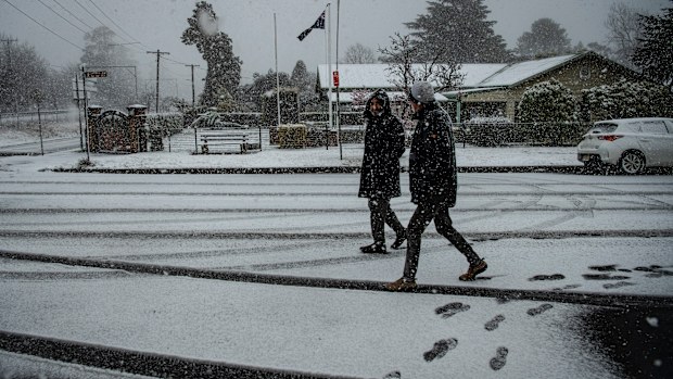 People walk in snow in Blackheath in the NSW Blue Mountains.