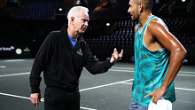 Nick Kyrgios talks with his Team World captain John McEnroe during a training session.