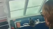 A freak wave hits the whale watching boat.