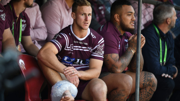 An injured Daly Cherry-Evans watches Manly from the bench.