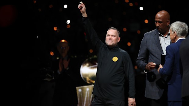 Denver Nuggets coach Michael Malone celebrates with his championship ring prior to the season-opener