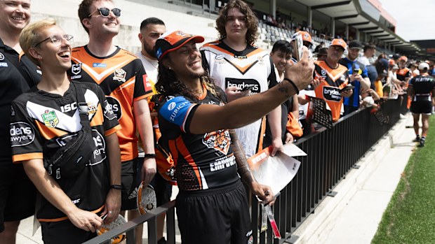 Wests Tigers recruit Jarome Luai poses with fans at an open training session at Concord Oval.