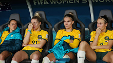 Ellie Carpenter, second from left, sinks her head in her hand as she reflects on the Matildas' loss to England alongside Hayley Raso (left), Steph Catley and Caitlin Foord.