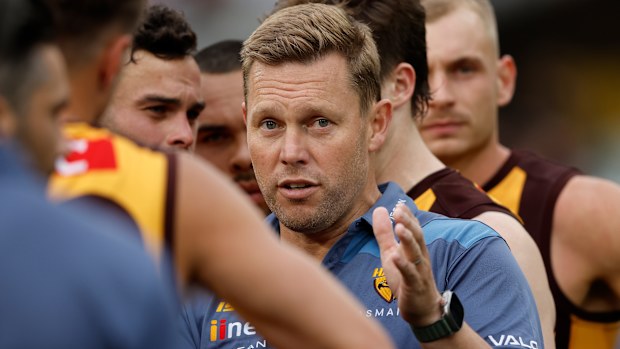 MELBOURNE, AUSTRALIA - MARCH 19: Sam Mitchell, Senior Coach of the Hawks addresses his players during the 2023 AFL Round 01 match between the Hawthorn Hawks and the Essendon Bombers at the Melbourne Cricket Ground on March 19, 2023 in Melbourne, Australia. (Photo by Dylan Burns/AFL Photos)