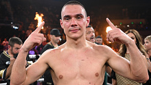 Tim Tszyu shows off his prized possession after his win.