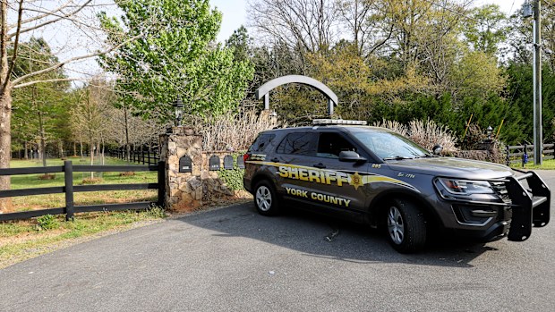 A York County sheriff's deputy is parked at 4456 Marshall Road, Rock Hill, S.C., Thursday, April 8, 2021, the sight where five people were killed on April 7, 2021. 