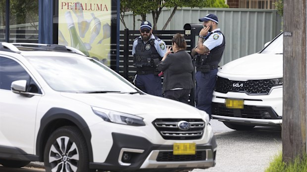 Police  talk with a local as they stand outside 103 Brighton Avenue, Campsie. The property is belived to have been rented by the gunmenyesterday who then went on tdo the  shooting rampage at Bondi Beach yesterday early evening, Sydney.