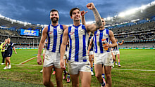 Jy Simpkin of the Kangaroos leads his team to the rooms after their win over West Coast.