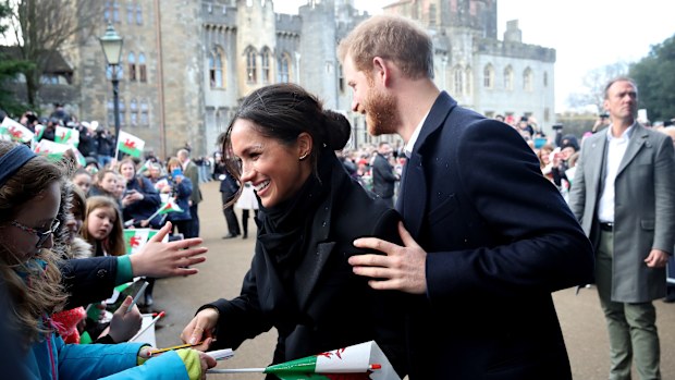 Prince Harry and Meghan Markle sign autographs and shake hands with children as they arrive to a walkabout at Cardiff Castle on January 18, 2018 in Cardiff, Wales.  (Photo by Chris Jackson/Chris Jackson/Getty Images)