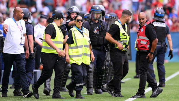 Armed police are seen on the sidelines at Stade Geoffroy-Guichard.