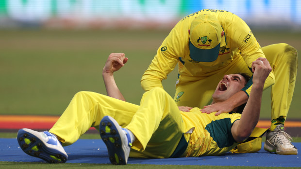 KOLKATA, INDIA - NOVEMBER 16: Pat Cummins of Australia celebrates with teammate Marnus Labuschagne after catching out Quinton de Kock of South Africa (not pictured) during the ICC Men's Cricket World Cup India 2023 Semi Final match between South Africa and Australia at Eden Gardens on November 16, 2023 in Kolkata, India. (Photo by Matthew Lewis-ICC/ICC via Getty Images)