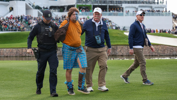 A fan dressed in costume as William Wallace from Braveheart is apprehended at the WM Phoenix Open.
