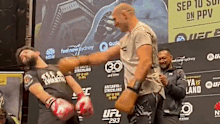 UFC star Sean Strickland spars with an Aussie fan on stage.