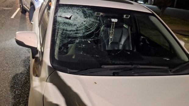 A car with damage to the windscreen from a rock.